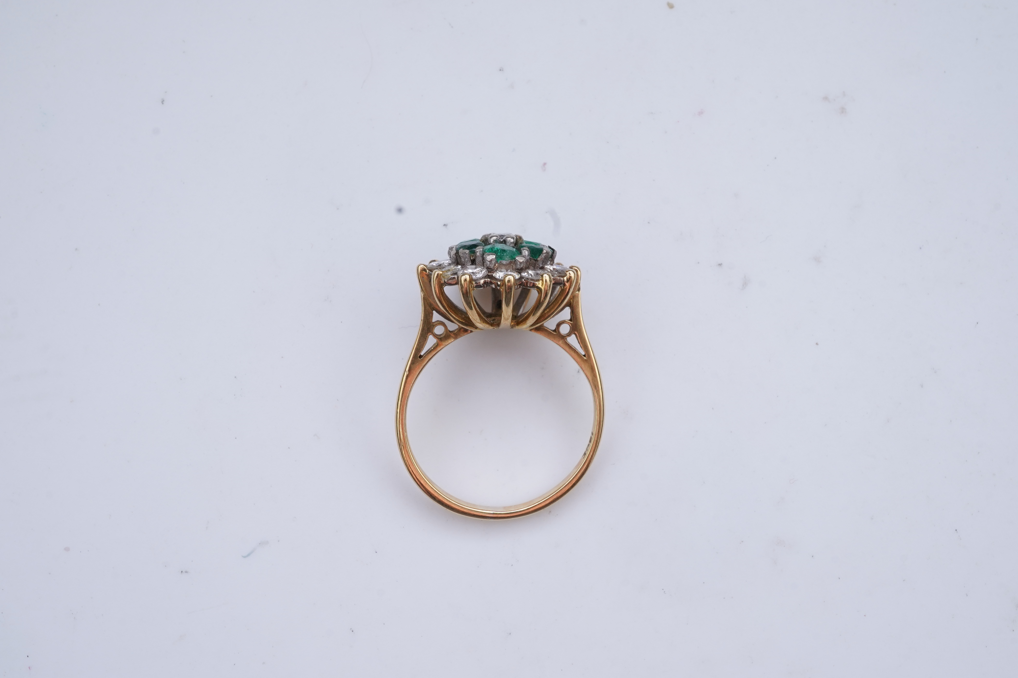 An emerald and diamond ring